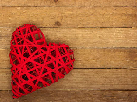 Red heart on a background of woodの写真素材