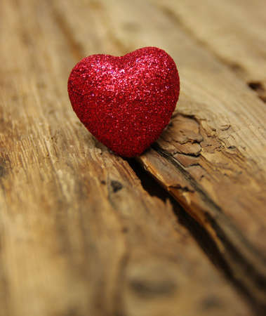 Red heart on a background of woodの写真素材