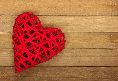 Red heart on a wood backgroundの写真素材