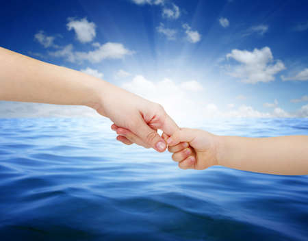 mother gives a hand of a child on landscapeの写真素材