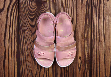 Child's sandals on a wooden backgroundの写真素材