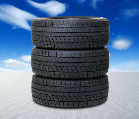 new black tyres for car on snow field in winterの写真素材