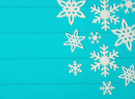 Snowflakes and stars on a blue wooden background