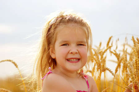 Girl on a wheat fieldの写真素材
