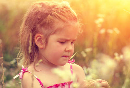 little girl on the meadow in spring dayの写真素材