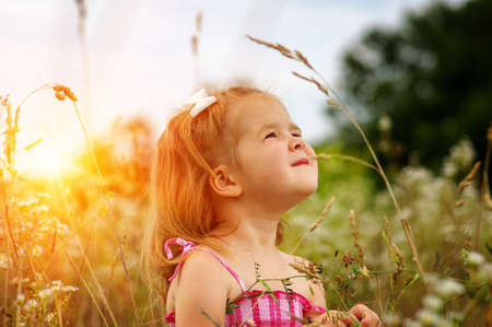 little girl on the meadow in spring day