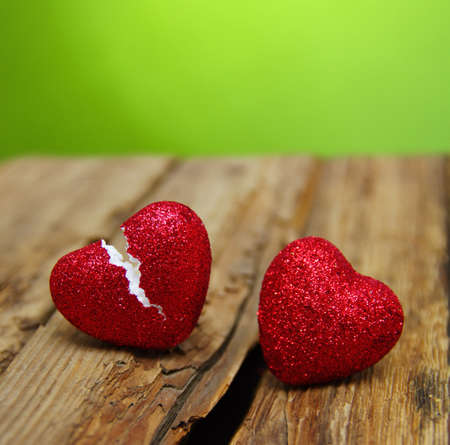 love concept. Broken heart cheating on wood and green  background.