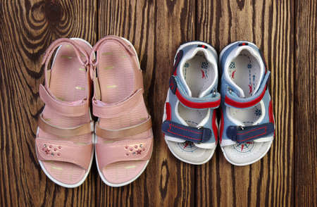 Child's sandals on a wooden backgroundの写真素材