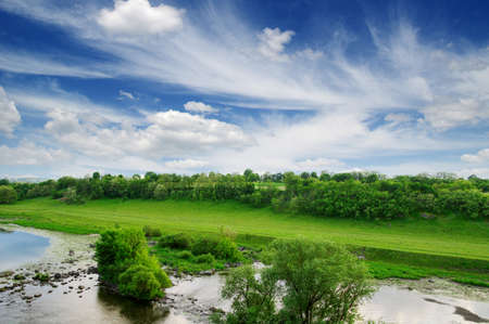 landscape with trees and a riverの写真素材