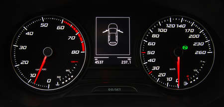 Car instrument panel, dashboard closeup with visible speedometer