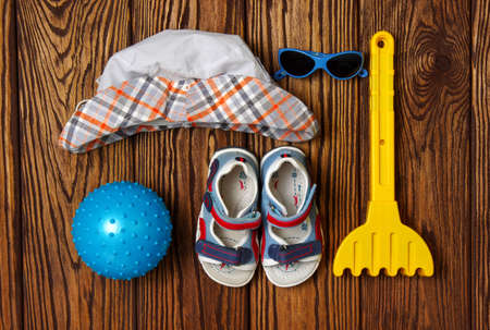 Summer accessories of kids on wooden backgroundの写真素材