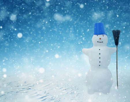 Snowman standing in winter christmas landscape. Snow backgroundの写真素材