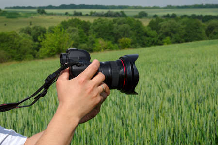 Photographer shoots nature with a cameraの写真素材