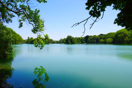 Lake water, shore and sun.の写真素材