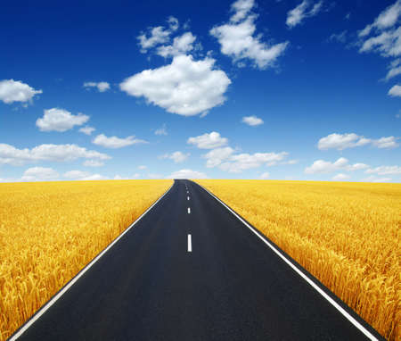 Asphalt car road and clouds on blue sky in summer dayの写真素材