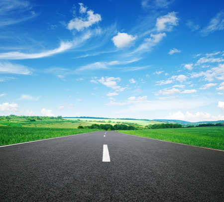 Asphalt car road and clouds on blue sky in summer day