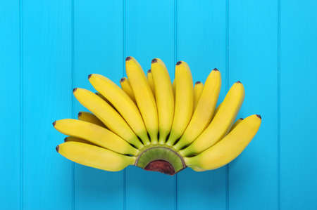 Bunch of baby banana on blue backgroundの写真素材