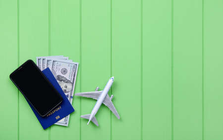 Traveler accessories on green wood background with blank space for text. Vacation concept. Flat lay, top view.の写真素材