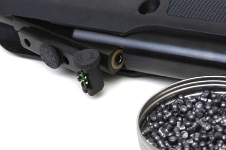 Black air rifle gun on a white background and lead pellets