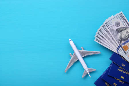 Traveler accessories on blue background with blank space for text. Vacation concept. Flat lay, top...