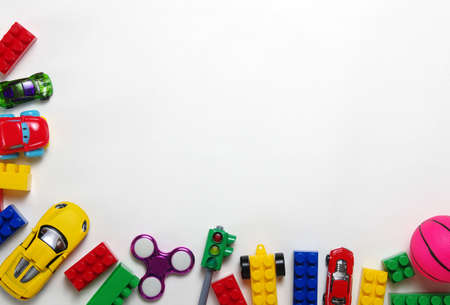 Kids toys frame on white background. Top view. Copy space for textの写真素材
