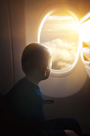 Little boy looking window airplaneの写真素材