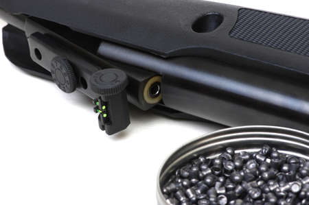 Black air rifle gun on a white background and lead pelletsの写真素材