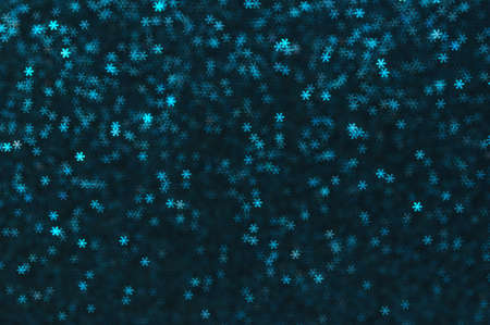 Blue snowflakes bokeh abstract background.  Christmas blurred shiny lights.