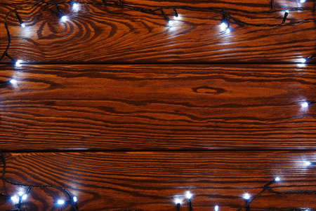 Christmas lights and vintage wood backgroundの写真素材