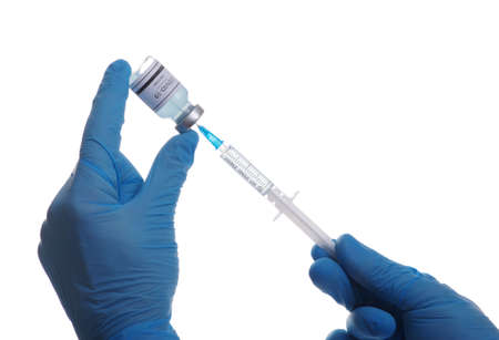 Doctor hand holding a syringe with vaccines isolated on white background. Vaccination, immunization, treatment to infection.の写真素材