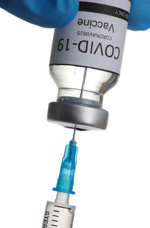 vaccine  in glass bottle in  doctor hand isolated on white background.の写真素材