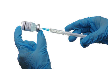 vaccine  in glass bottle in  doctor hand isolated on white background.の写真素材