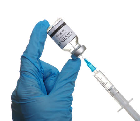 Doctor hand holding a syringe with vaccines isolated on white background. Vaccination, immunization, treatment to infection.の写真素材