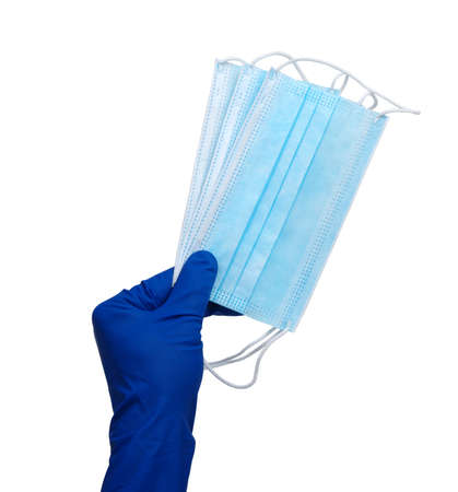 Doctor holding medical face mask in hands in blue gloves. Isolated on white background.の写真素材