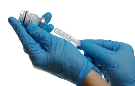 Doctor hand holding a syringe with vaccines isolated on white background. Vaccination, immunization, treatment to infection.の写真素材