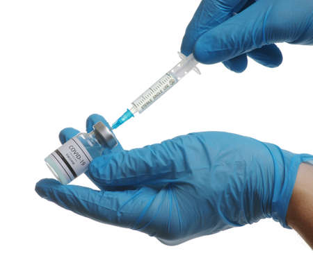 vaccine  in glass bottle in  doctor hand isolated on white background.の写真素材