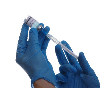 Doctor hand holding a syringe with vaccines isolated on white background. Vaccination, immunization, treatment to infection.の写真素材
