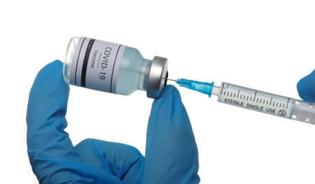 Doctor hand holding a syringe with vaccines isolated on white background. Vaccination, immunization, treatment to infection.の写真素材