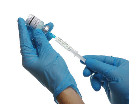 vaccine  in glass bottle in  doctor hand isolated on white background.の写真素材