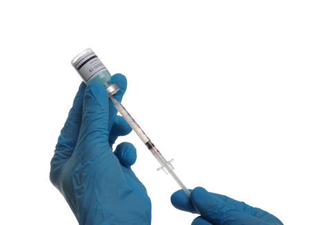 Doctor hand holding a syringe with vaccines isolated on white background. Vaccination, immunization, treatment to infection.の写真素材