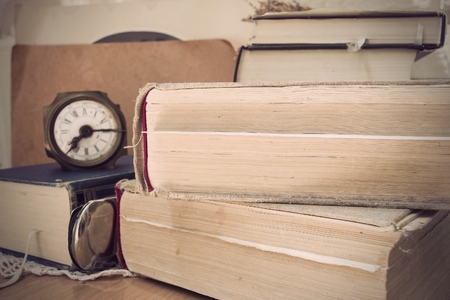 Vintage photo with old books and clockの写真素材