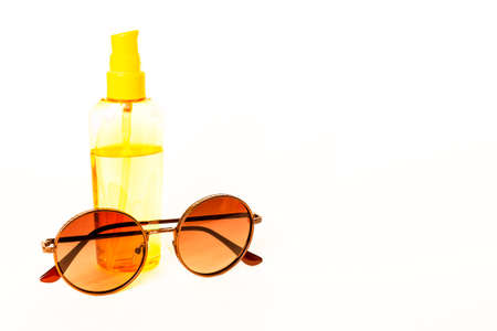 Sunscreen and glasses isolated on white background.の写真素材