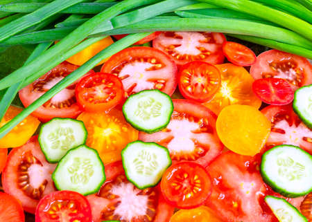 Vegetable background. Tomato and cucumber slices.の写真素材
