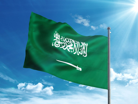 Saudi Arabia flag waving in the blue skyの写真素材