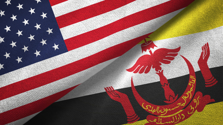United States and Brunei Darussalam flags together textile cloth, fabric texture. Text on brunei flag means - Always in service with God's guidanceの写真素材