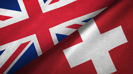 United Kingdom and Switzerland flags together relations textile cloth, fabric textureの写真素材