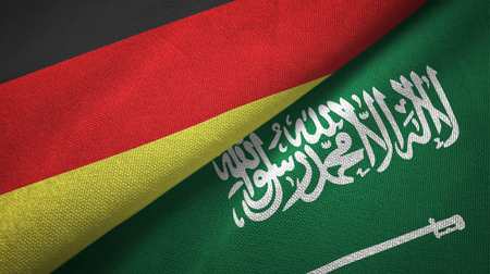 Germany and Saudi Arabia flags textile cloth, fabric texture. Text on saudi arabian flag means - There is no god but God, Muhammad is the Messenger of Godの写真素材