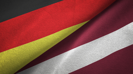 Germany and Latvia flags together relations textile cloth, fabric textureの写真素材