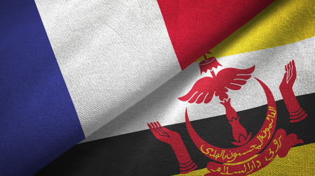 France and Brunei Darussalam flags together relations textile cloth, fabric texture. Text on brunei flag means - Always in service with God's guidanceの写真素材