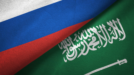 Russia and Saudi Arabia flags textile cloth, fabric texture. Text on saudi arabian flag means - There is no god but God, Muhammad is the Messenger of Godの写真素材